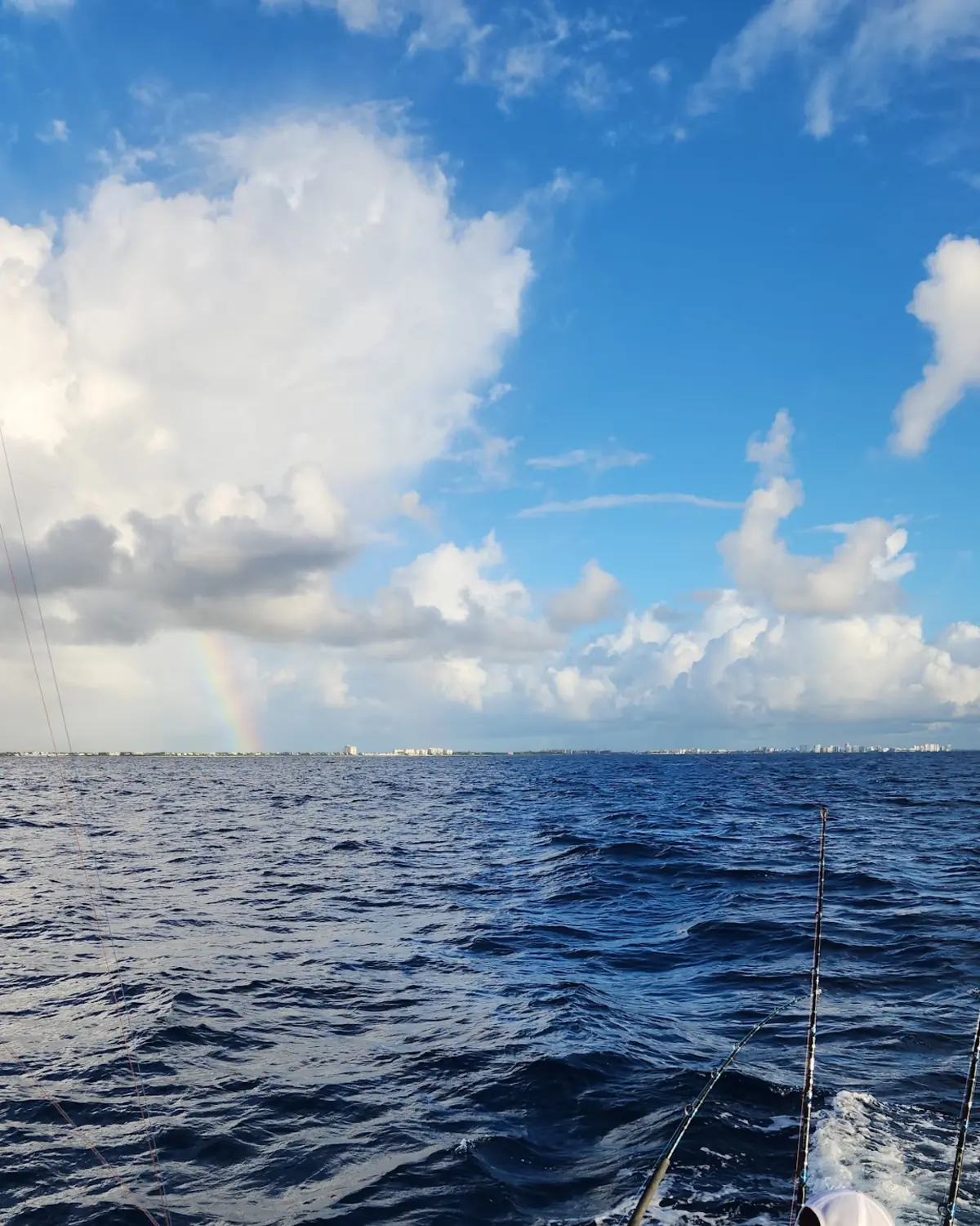 An angler working a rod in deep blue water on the wreck grounds off Pompano Beach